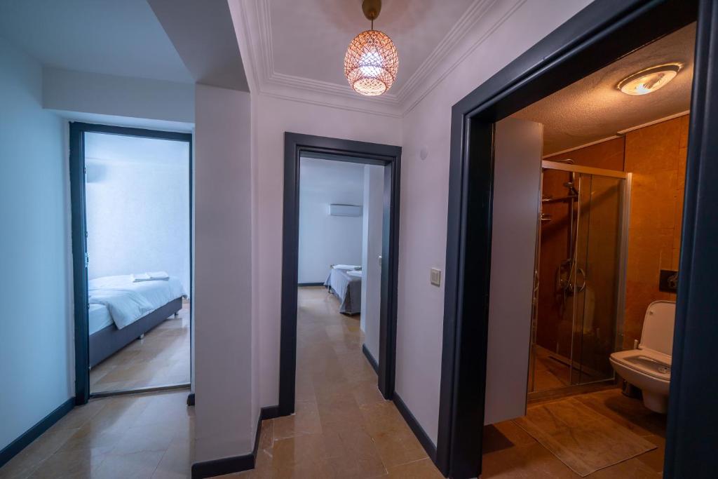 a hallway with a room with a bed and a bathroom at İlya Apart 2 in Bodrum City