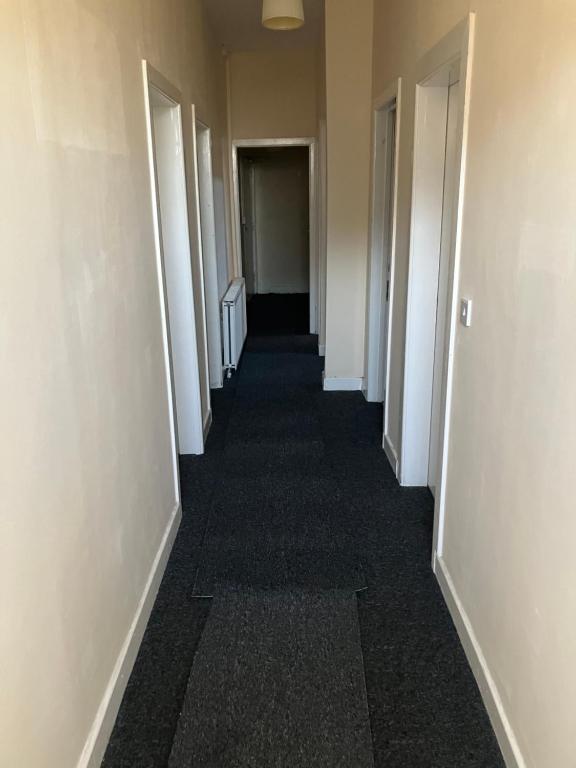 a hallway of an office building with white doors at Astley House - Manchester in Dukinfield