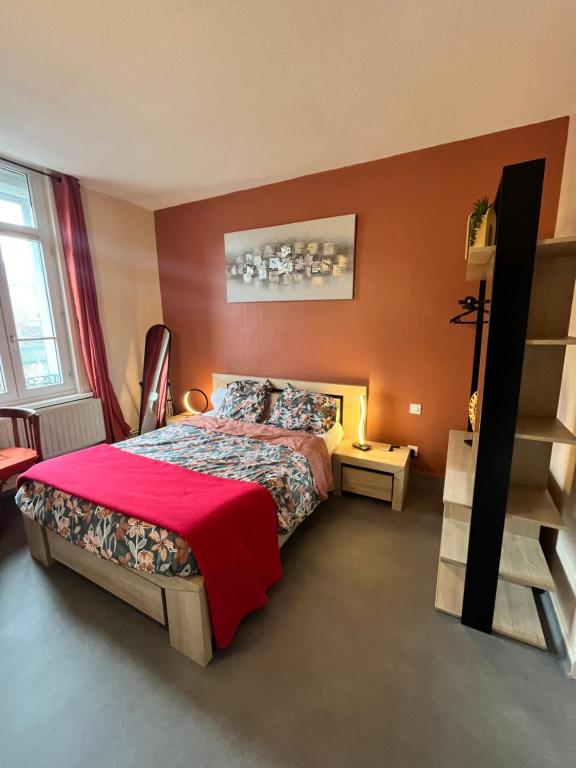 GuiseにあるHôtel de Guise SARLのベッドルーム1室(赤毛布付きの大型ベッド1台付)