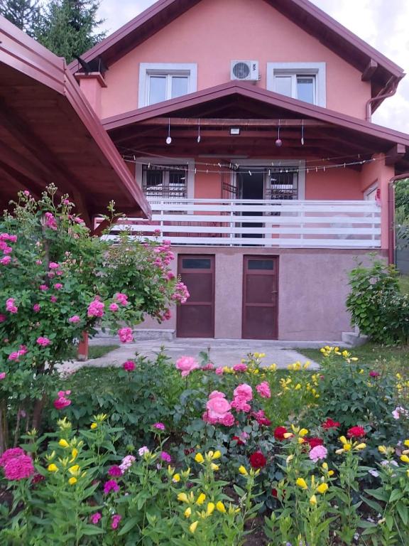 a pink house with flowers in front of it at Villa Bella in Ilidža