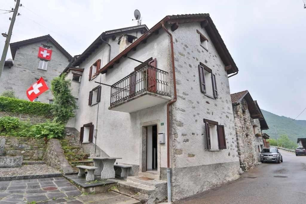 a building with a balcony on the side of it at Centovalli & Nature in Palagnedra