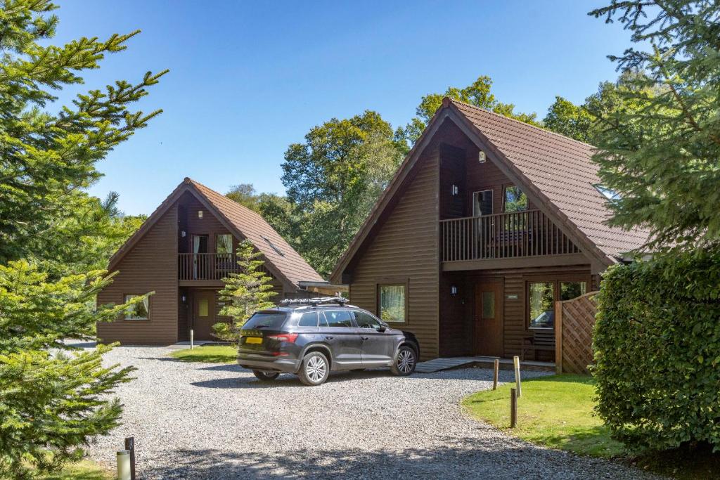 a car parked in front of a house at Loch Lomond Luxury Lodges in Drymen