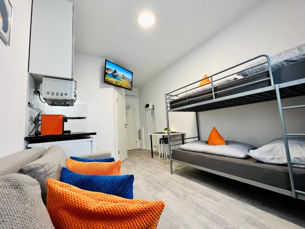 a living room with a bunk bed and a couch at Ferienwohnung, Monteur-Appartment R11 in Freiberg am Neckar