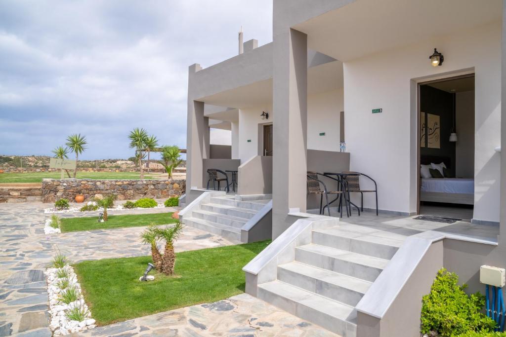 a villa with a staircase leading to a backyard at Lafo Rooms in Elafonisi