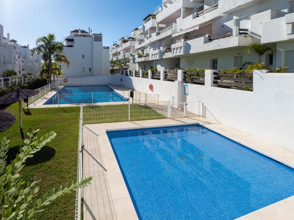an image of two swimming pools on the side of a building at 2051-New 3 bedrooms on golf in Estepona