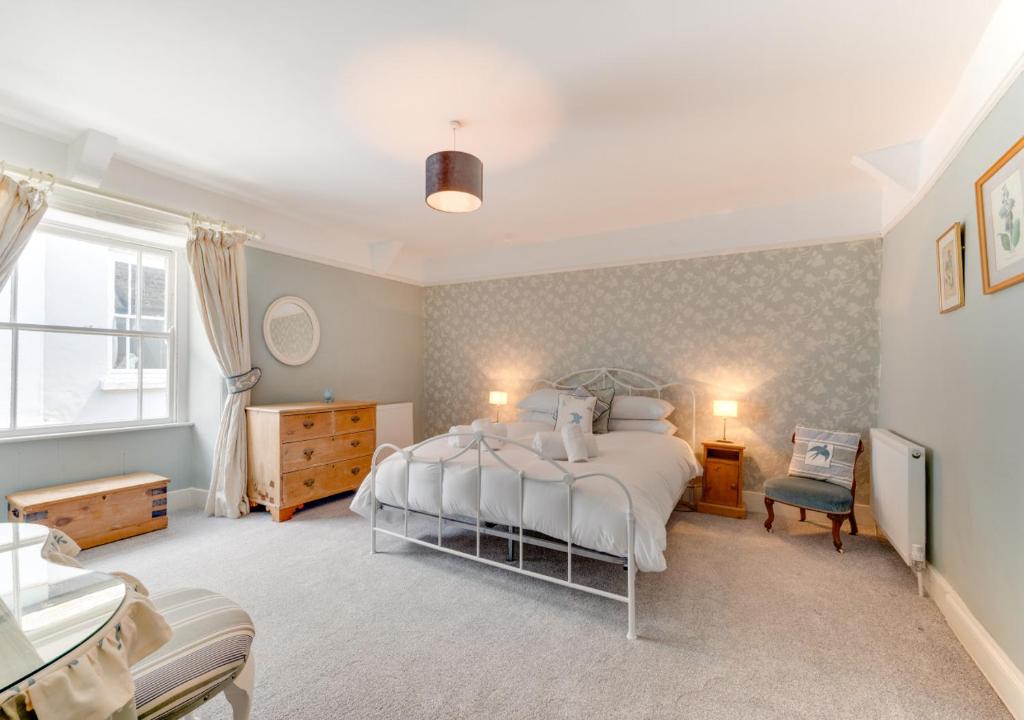 a bedroom with a large bed and a bathroom at Cosy Nook in Appledore