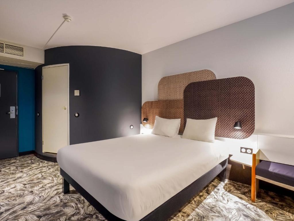 ルーアンにあるB&B HOTEL Rouen Centre Rive Droiteのベッドルーム1室(白い大型ベッド1台付)