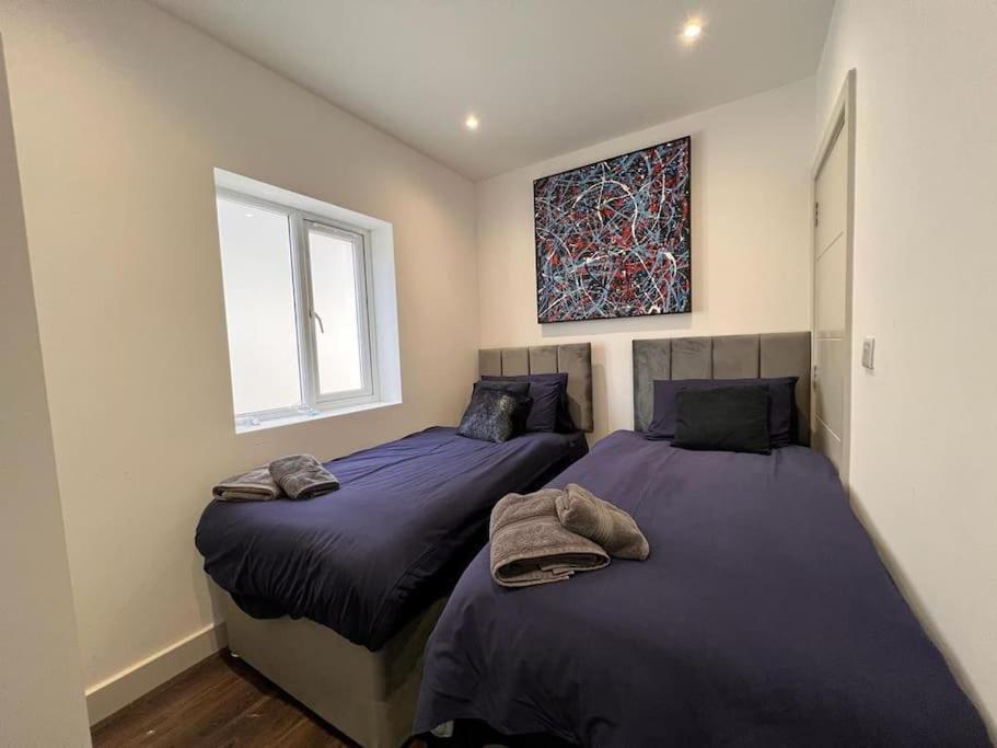 a bedroom with two beds and a window at Star London Finchley Road 1-Bed Hideaway in London