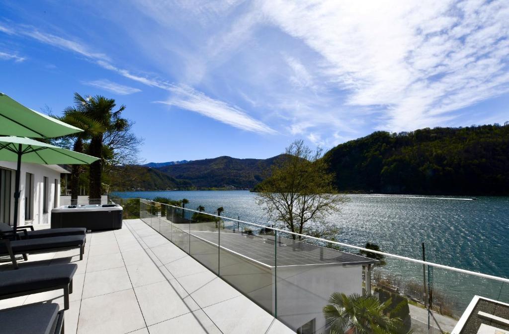 a balcony of a house with a view of a lake at Sans Souci 1 in Caslano