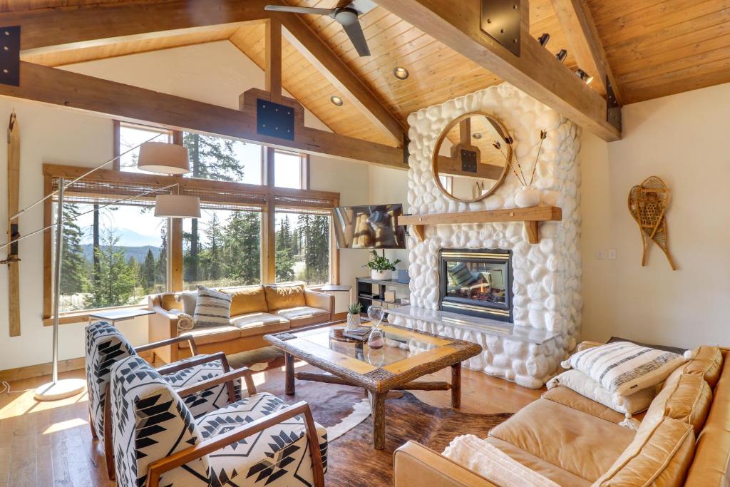 a living room with a stone fireplace in a house at Ski-InandSki-Out Whitefish Duplex with Hot Tub! in Whitefish