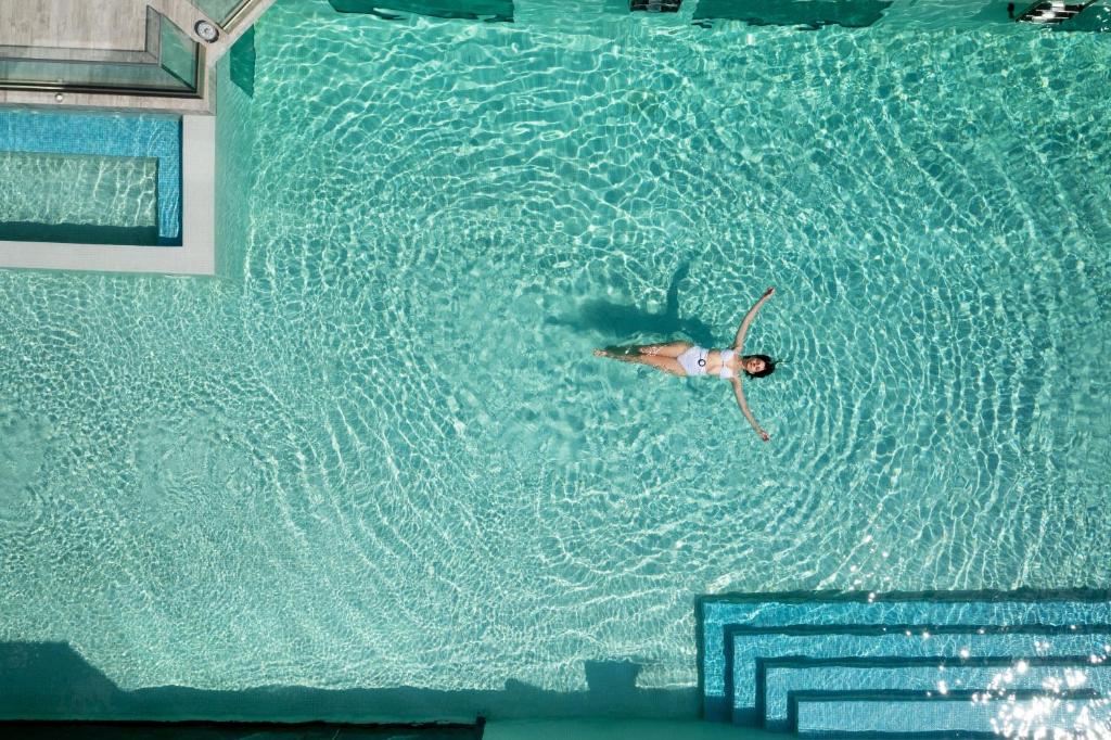 a man swimming in a pool of water at Akti Toroni Boutique Hotel in Toroni