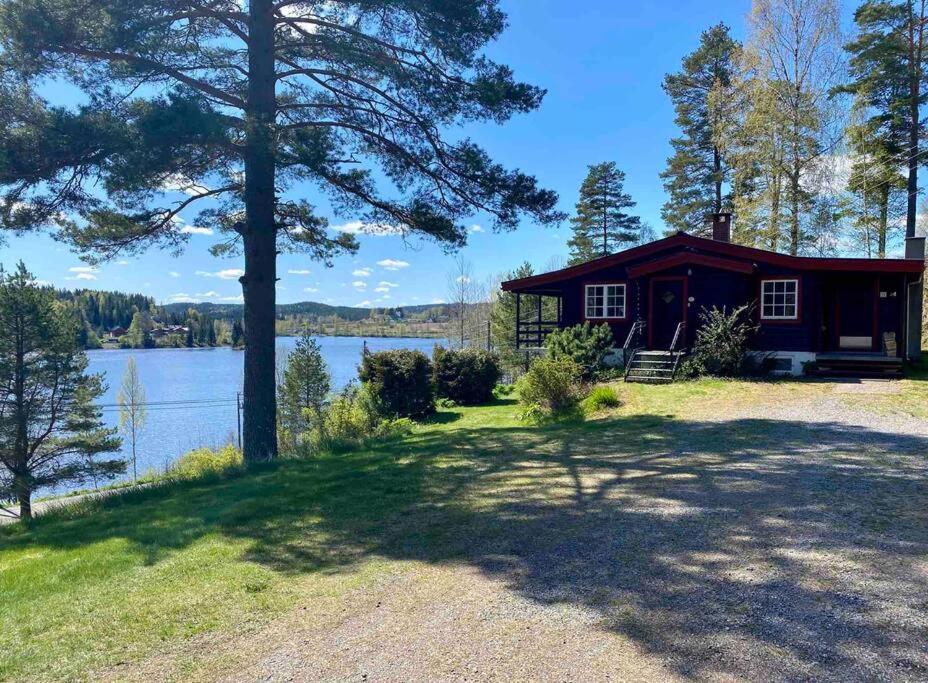 a cabin on the shore of a lake at Lakefront Cabin in Magnor