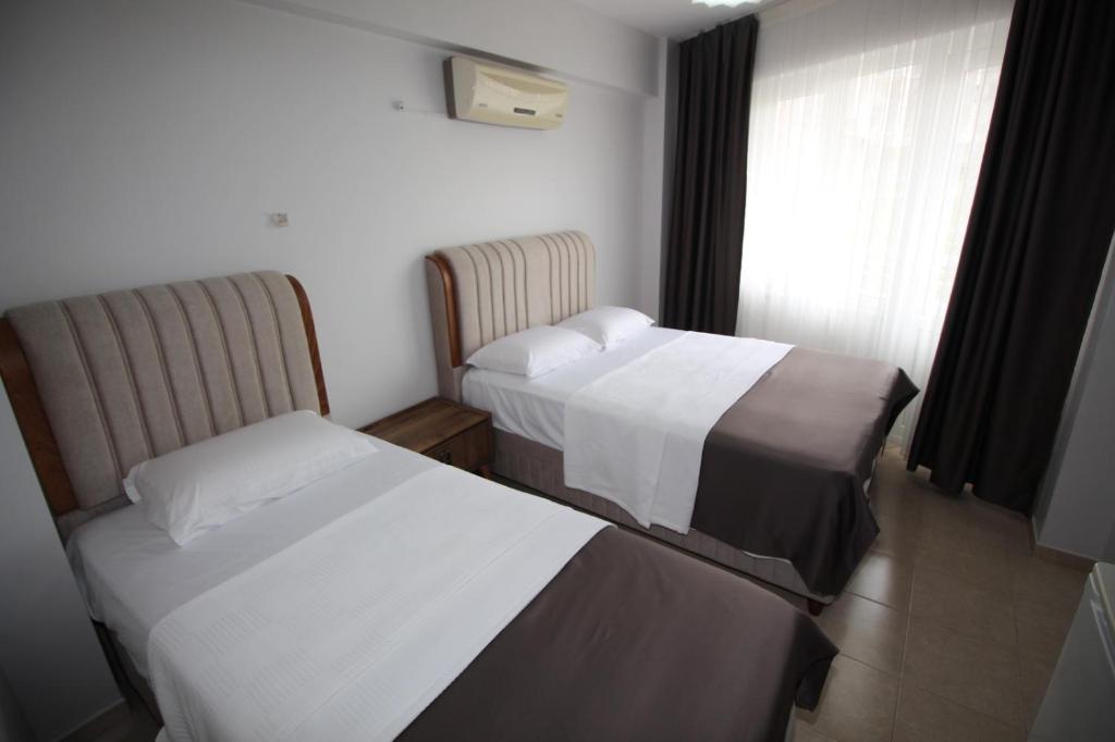 a hotel room with two beds and a window at Pegasus Motel in Avşa Adası