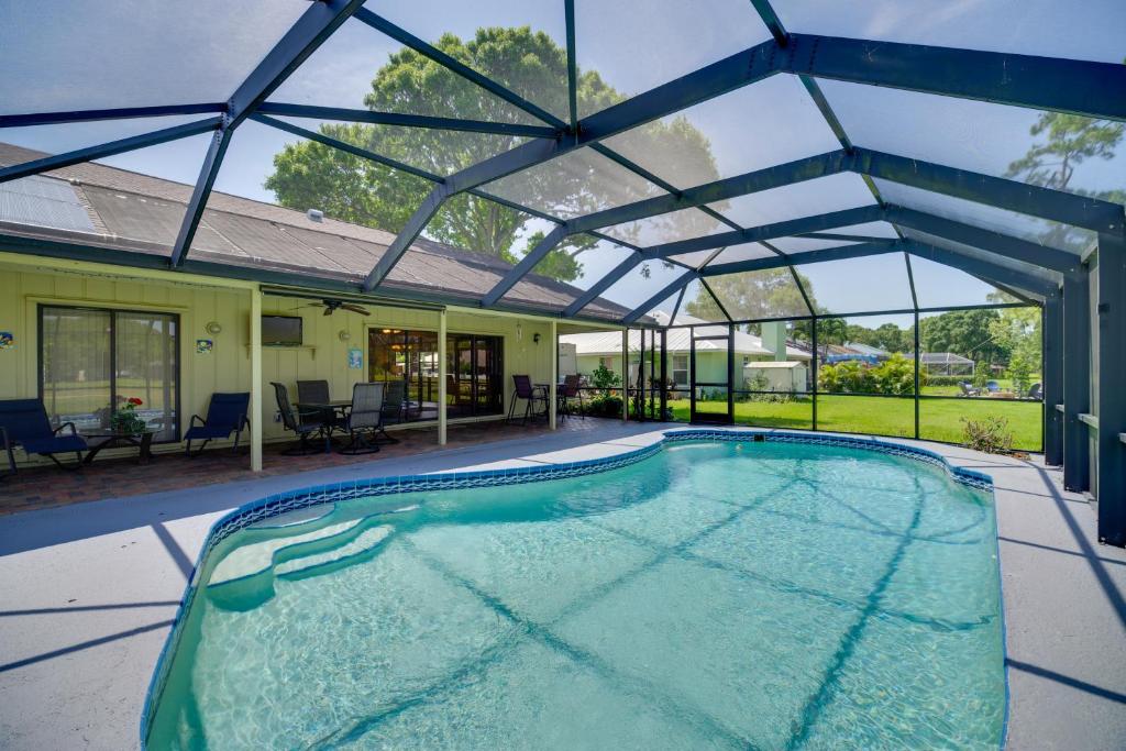 a swimming pool in a house with a glass roof at Lakewood Park Retreat on Fairway - 4 Mi to Beach! in Lakewood Park