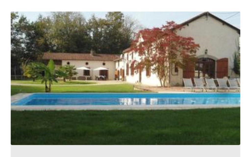 a large swimming pool in front of a house at Domaine Manon in Buzon