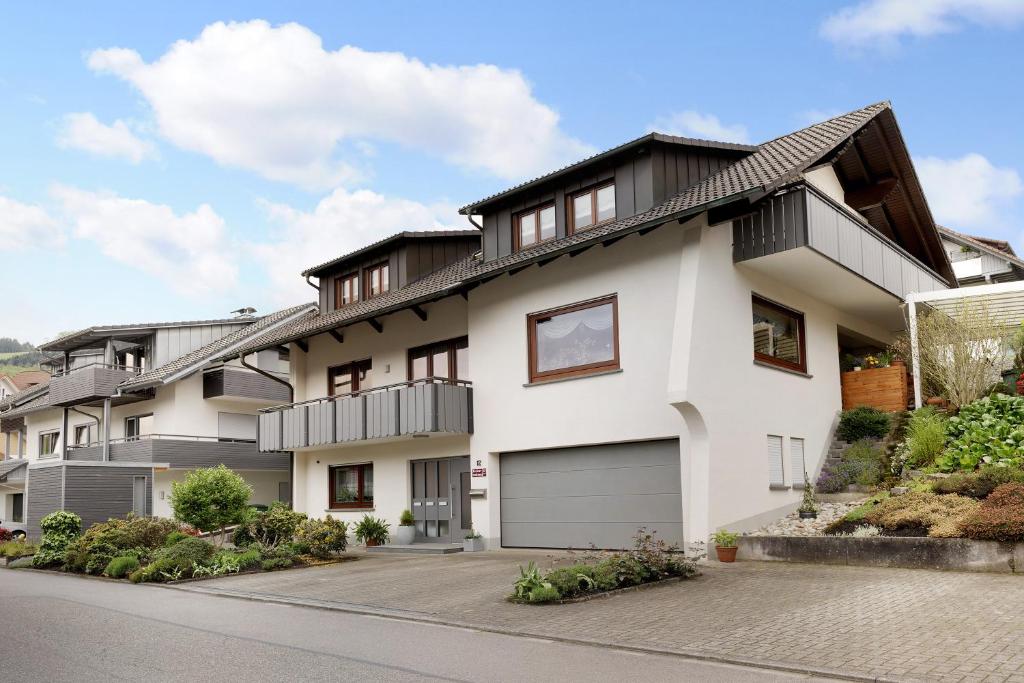 a white house with a black roof at Gieringer in Oberharmersbach