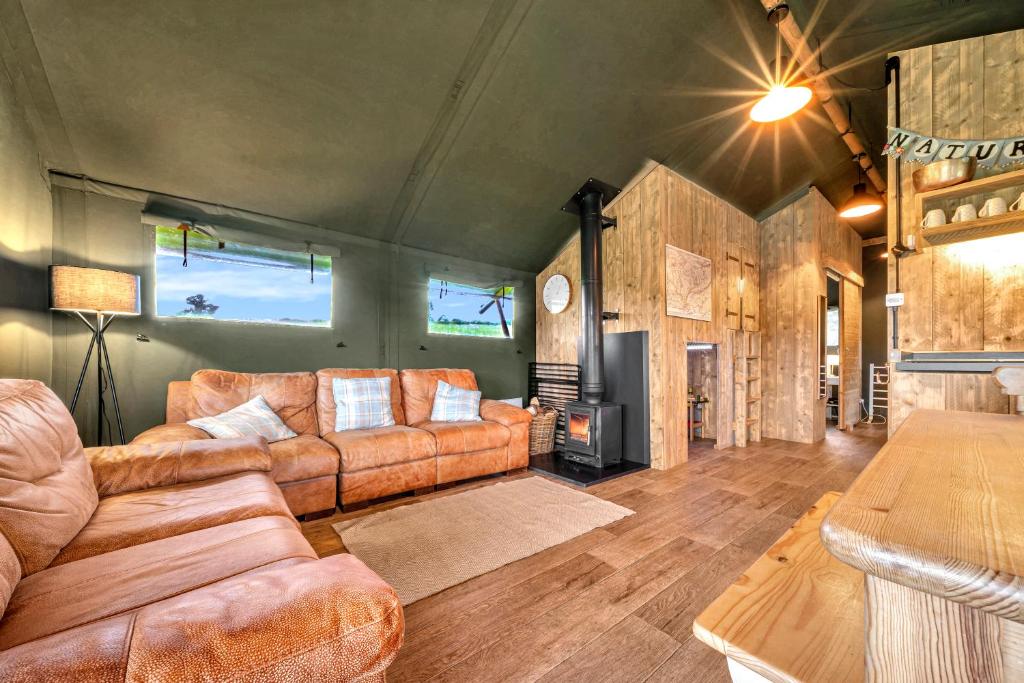 a living room with a couch and a fireplace at Nature's Nest in Hereford