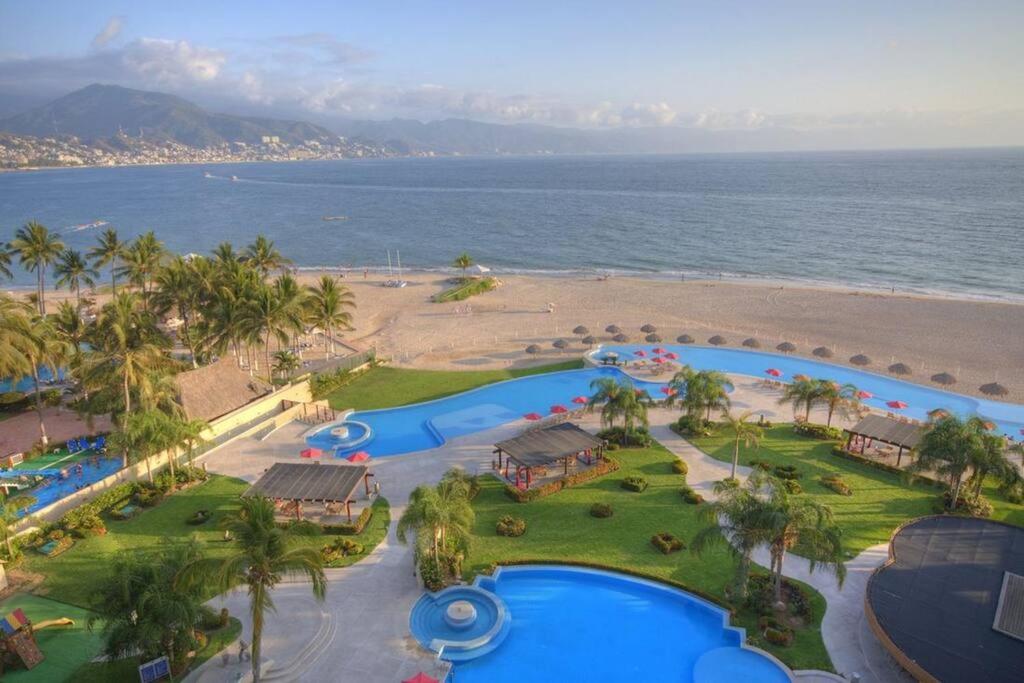 an aerial view of a resort with a beach at Ocean front Grand Venetian corner condo in Puerto Vallarta