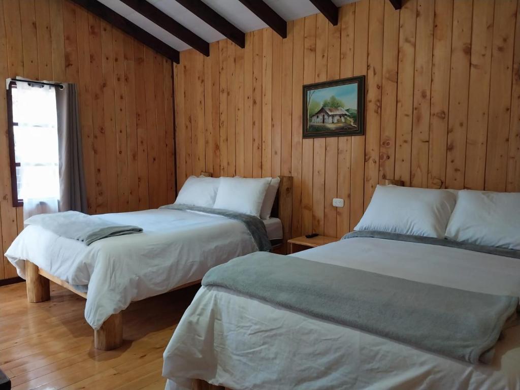 Postel nebo postele na pokoji v ubytování Curuba Lodge