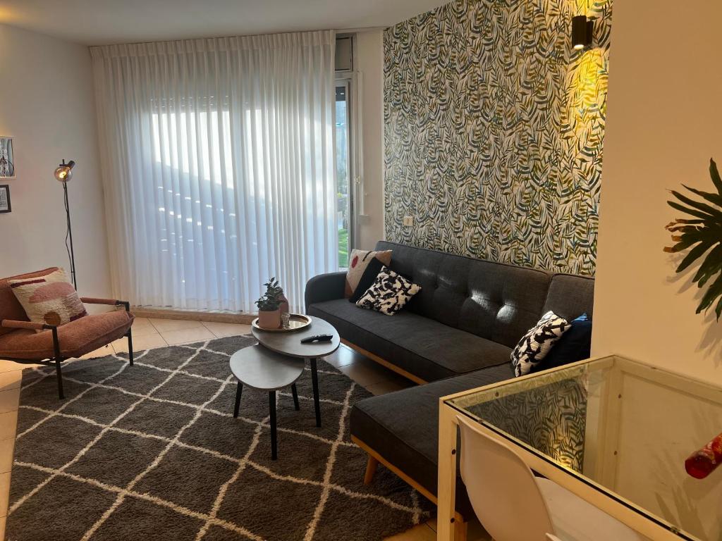 a living room with a couch and a table at Garden apt at the Marina Herzliya in Herzliyya B