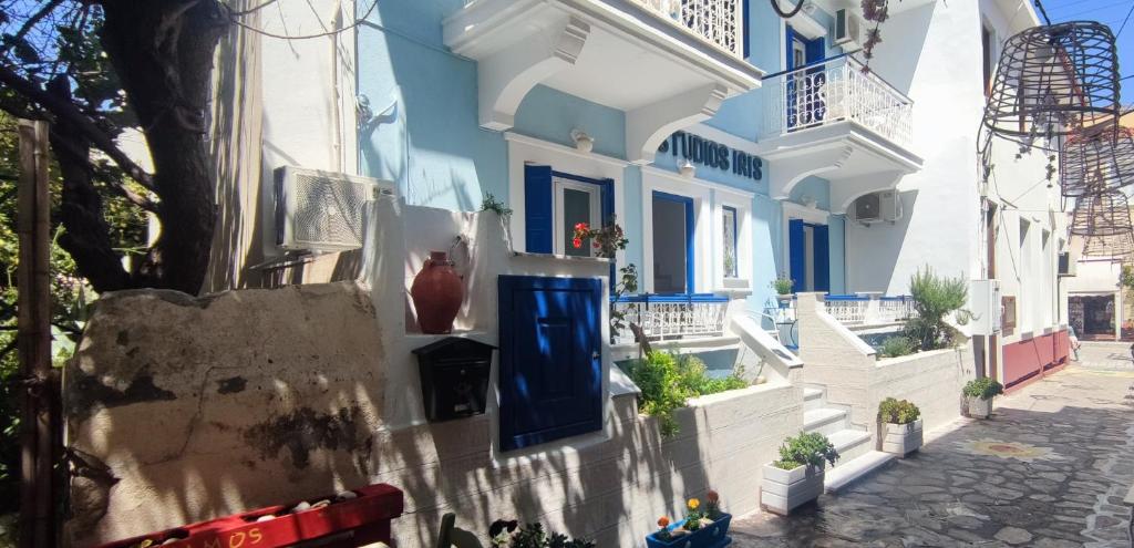 a building with a blue door and white walls at Studios Iris in Pythagoreio