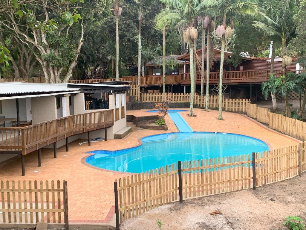 a swimming pool in the middle of a resort at Anerley Garden Park Resort in Port Shepstone
