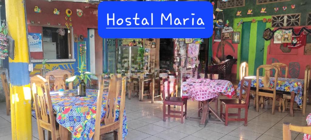 a restaurant with tables and chairs and a sign that reads hospital marina at Hostal Maria in Rivas