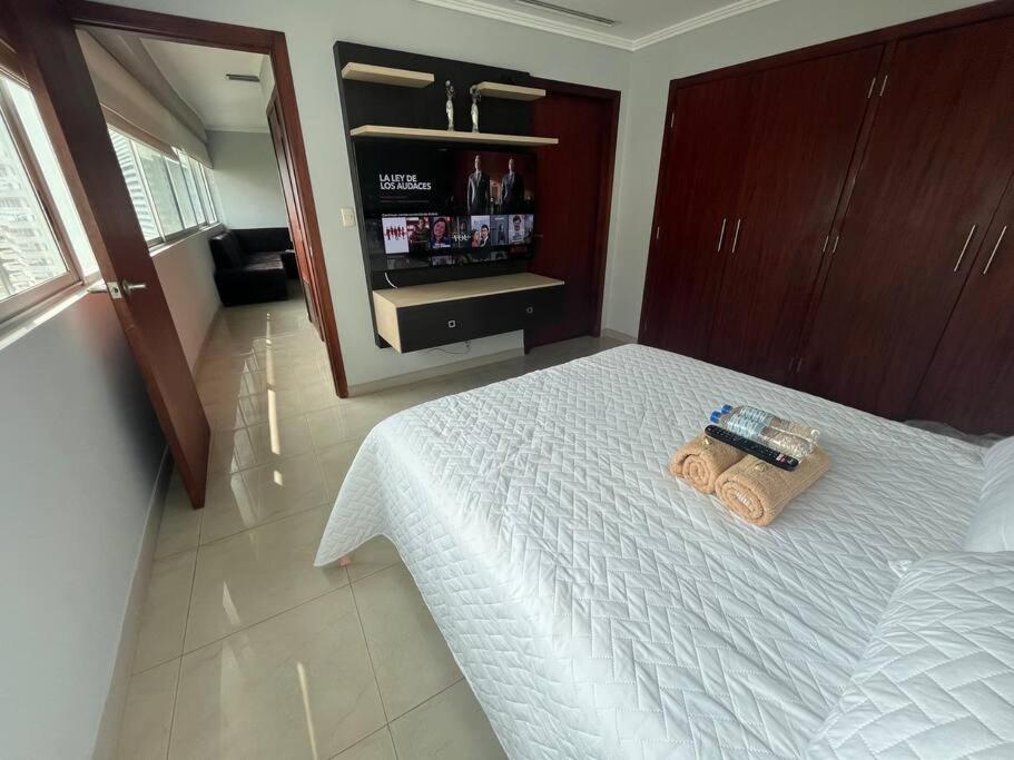 a bedroom with a bed with a towel on it at Suite en Puerto Santa Ana! in Guayaquil