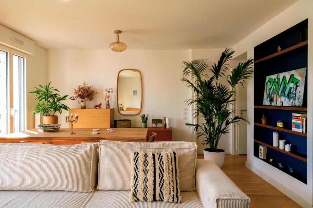 a living room with a couch and a mirror at Stunning apartment with balcony to visit Paris in Paris