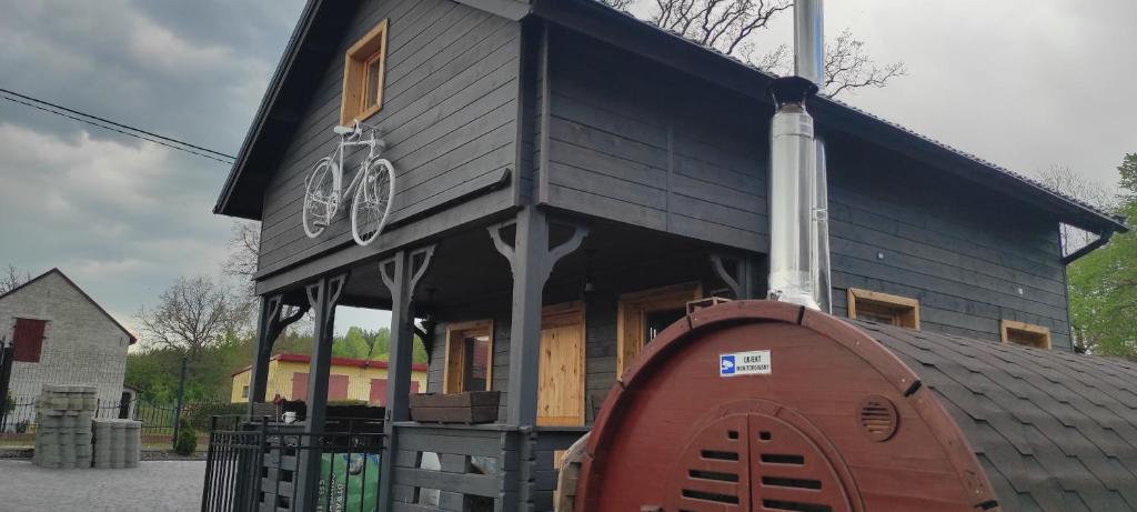 a house with two bikes on the side of it at Domek nad jeziorem Drężno noclegi wynajem+sauna 