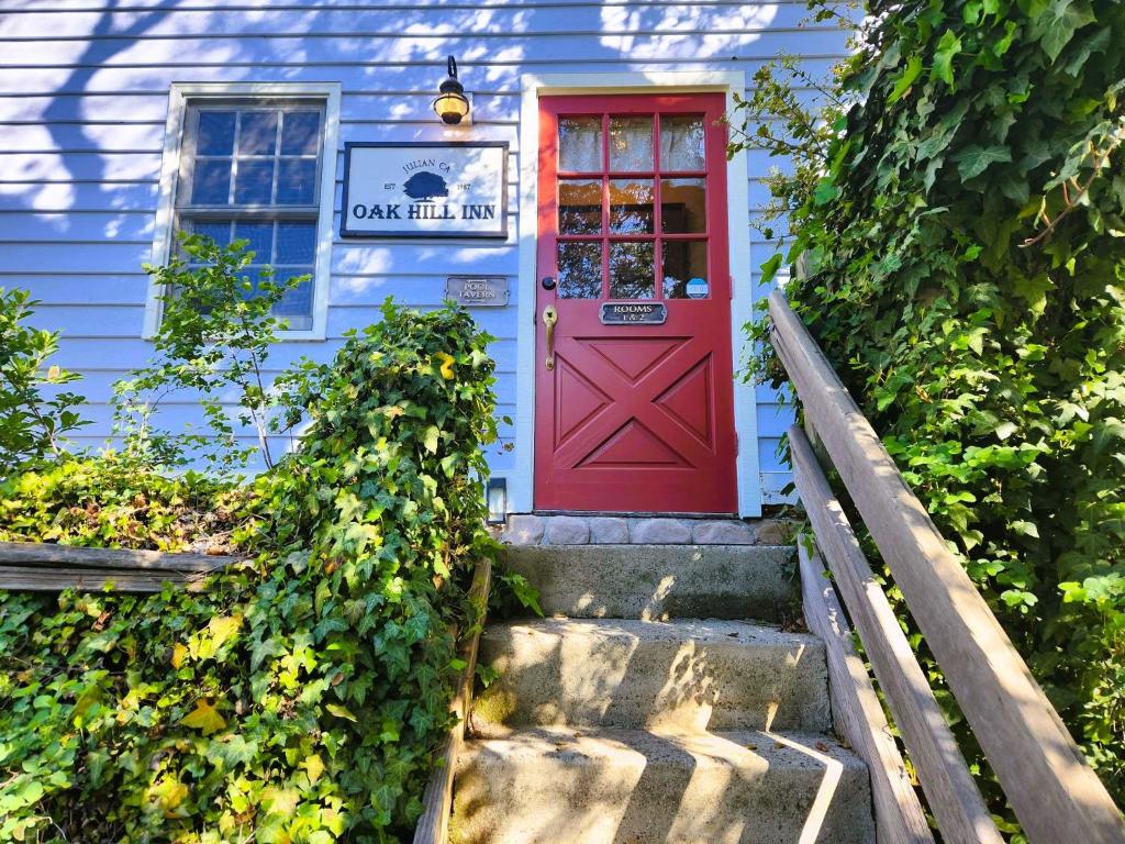 a red door on a blue house with stairs at Oak Hill Inn in Julian