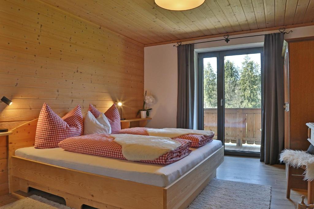 a bedroom with a bed with red and white pillows at Landhaus Barbara in Kitzbühel