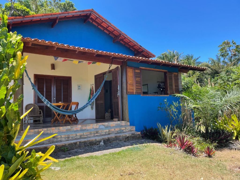 a blue house with a hammock in front of it at Casa nos Algodoes in Marau