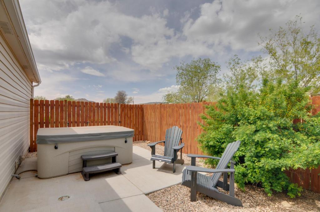 a patio with two chairs and a grill at Utah Retreat - Hot Tub, Deck and Near National Parks in Escalante