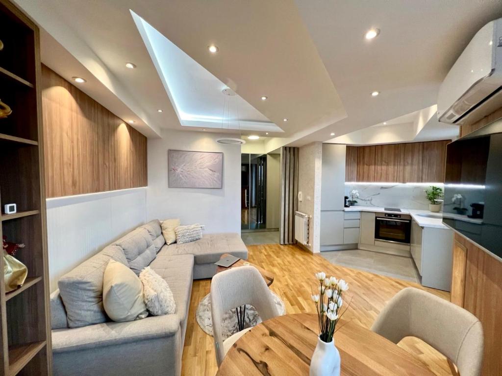 a living room with a couch and a table at Maria's Elite Luxury Apartment Skopje in Skopje