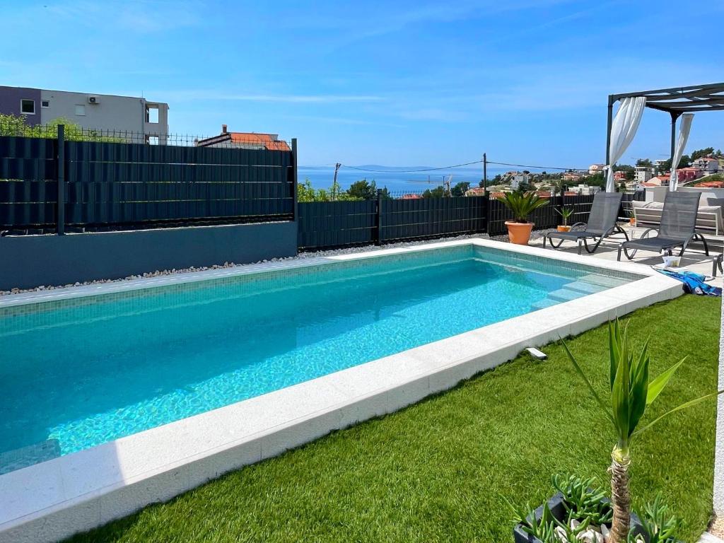 a swimming pool on the roof of a house at Villa Fortuna in Podstrana