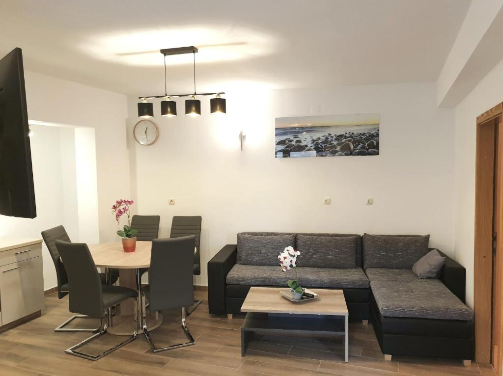 a living room with a couch and a table at Apartments Beleca in Biograd na Moru