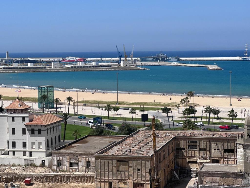 a view of a city with a beach and the ocean at Studio Relax à Malabata Tanger in Tangier