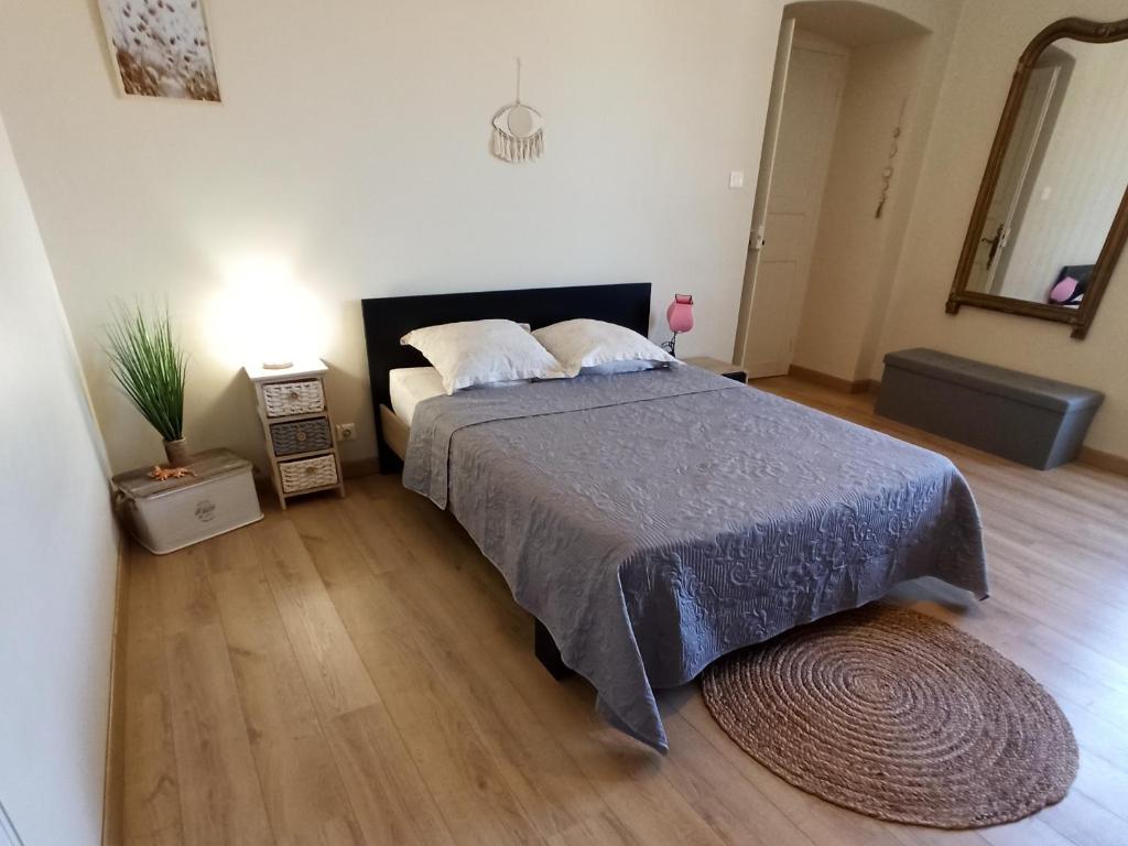 a bedroom with a large bed and a wooden floor at Chez Laurette Murato in Murato