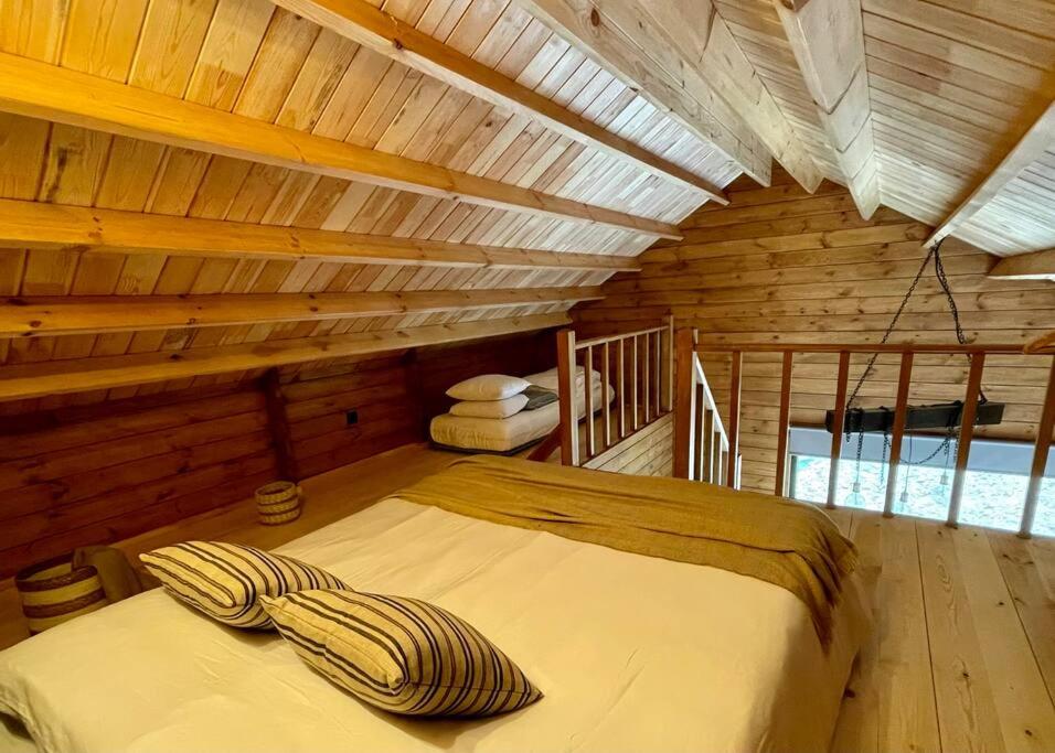 a bedroom with a bed in a wooden cabin at Mountain Eco Shelter 9 in Funchal