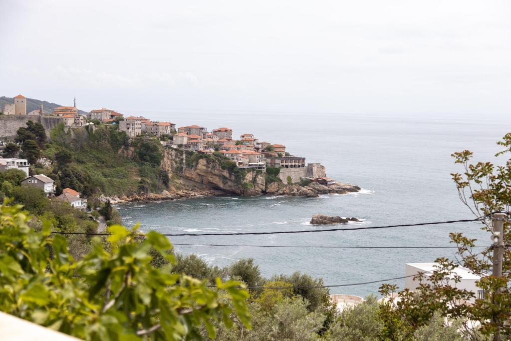 einen Blick auf das Meer von einem Hügel mit Häusern in der Unterkunft Apartments Hodžić in Ulcinj