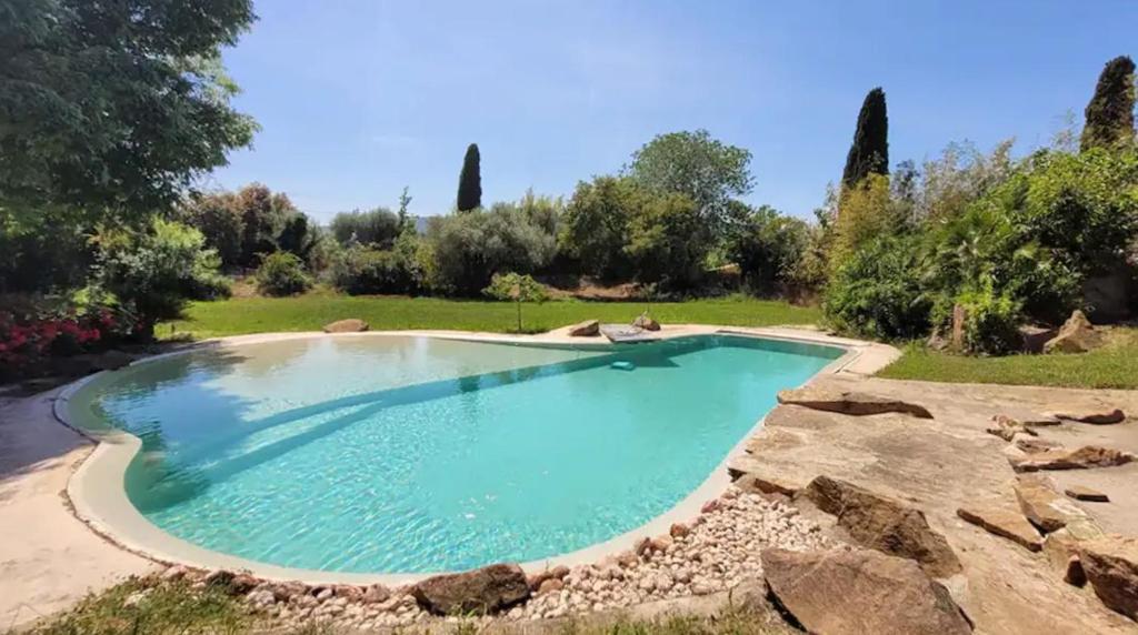 a swimming pool in the middle of a yard at Villa Pio in Roquebrune-sur-Argens