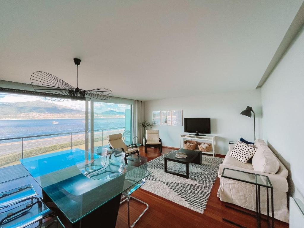 a living room with a view of the ocean at Just Like Home - Oceanside Walk in Caminha