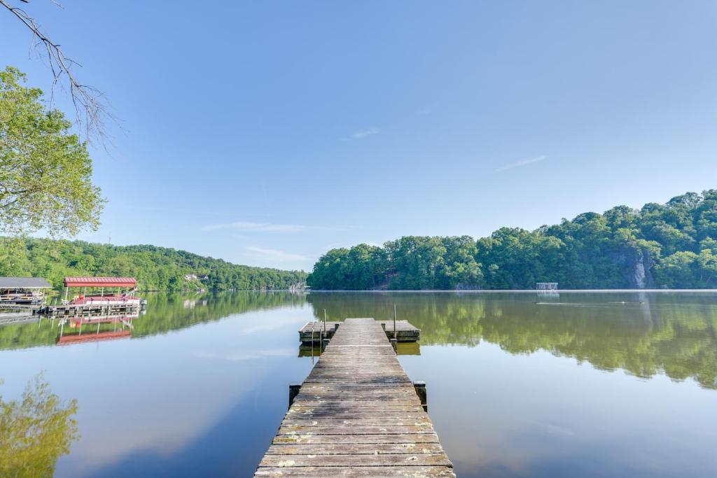 a dock on a lake with trees in the background at Lakefront Kingsport Home with Private Hot Tub! in Kingsport