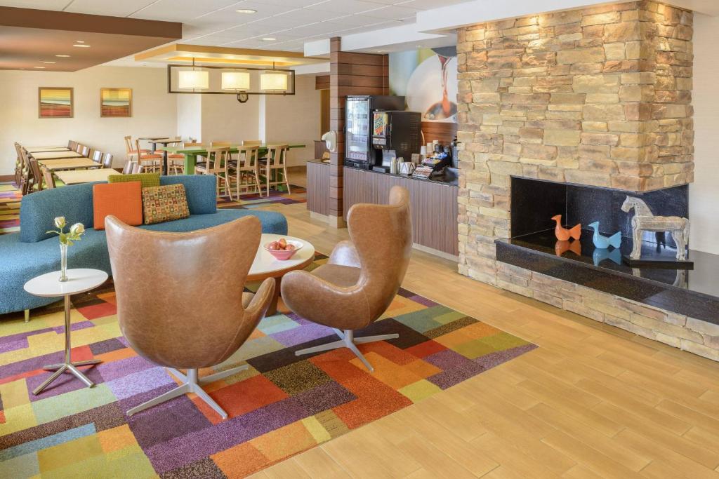 a lobby with a couch and chairs and a fireplace at Fairfield Inn Indianapolis South in Indianapolis