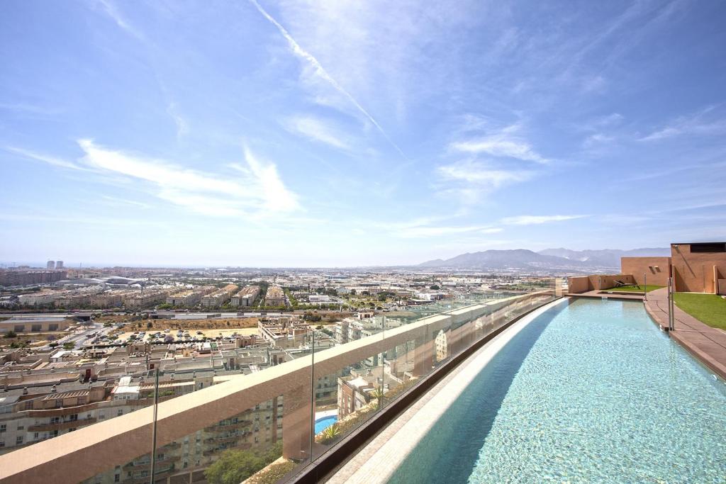 uma piscina no telhado de um edifício em -MalagaSunApts-SkyGarden Teatinos Pool Playground em Málaga