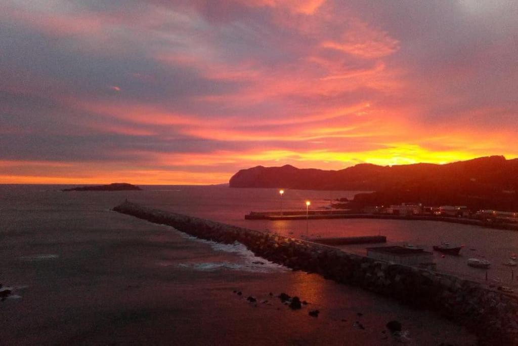 puesta de sol sobre una playa con muelle en FrantzunatxakVistas al mar EBI10012, en Bermeo