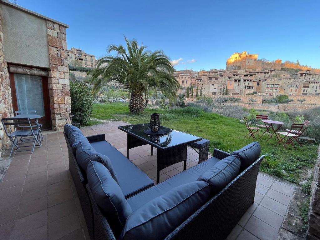 a patio with couches and a table with a view at Casa Margherita in Alquézar