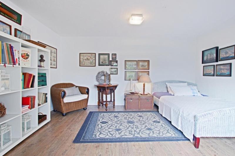 a bedroom with a bed and a chair and a table at Private Apartment in Hannover