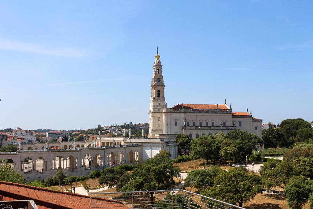 a large building with a tower on top of it at Apartamento Fátima Sanctuary in Fátima